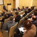 A photo of a presentation from the perspective of the audience.