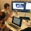Students talking at a table.